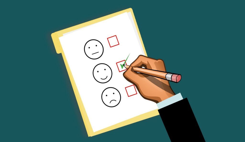 Illustration of a hand marking the neutral face option on a feedback survey sheet with neutral, happy, and sad face choices.