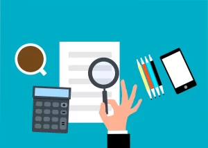 A hand holding a calculator, with emphasis on team building program customization through careful examination and analysis.
