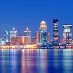 A city skyline reflected in a body of water.