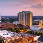 An aerial view of a city at dusk, ideal for team building in Tallahassee.