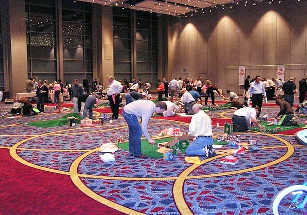 A group of people playing a game of miniature golf.