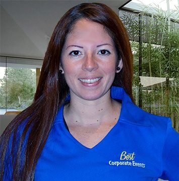 A woman in a blue shirt posing for a photo.