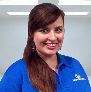A woman in a blue shirt smiling for the camera.