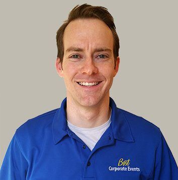 A man in a blue shirt smiling.