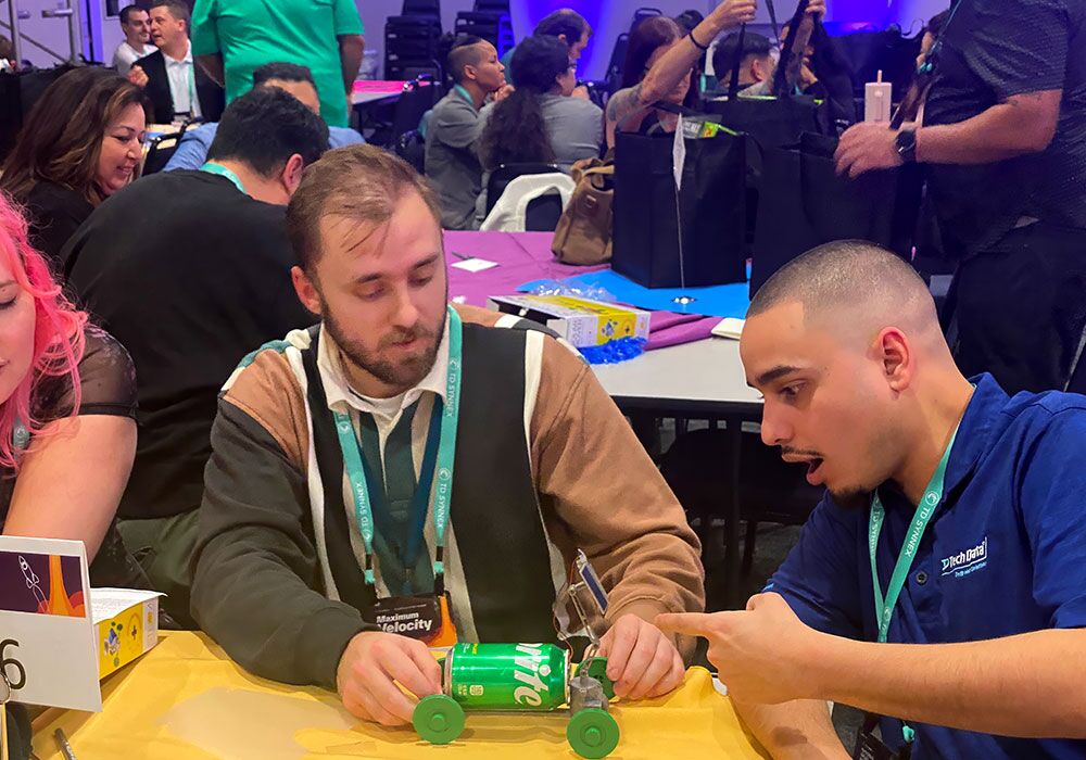 A group of people at a table playing a game.