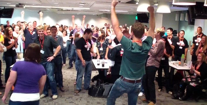 A group of people dancing in a room.