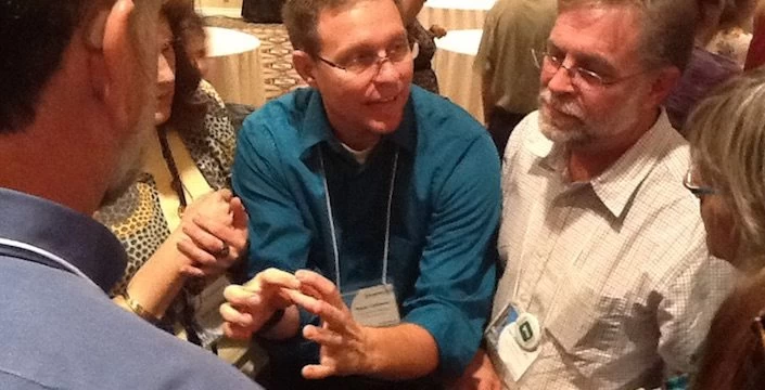 A group of people talking to each other at a conference.