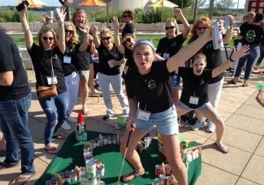 A group of people posing in front of a golf course.