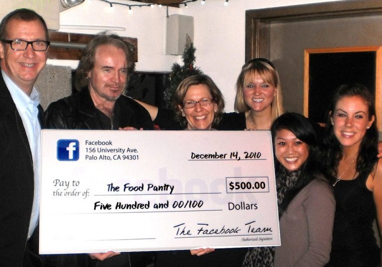 A group of people posing with a check for the food pantry.