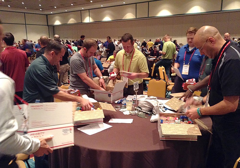 A group of people standing around a table.