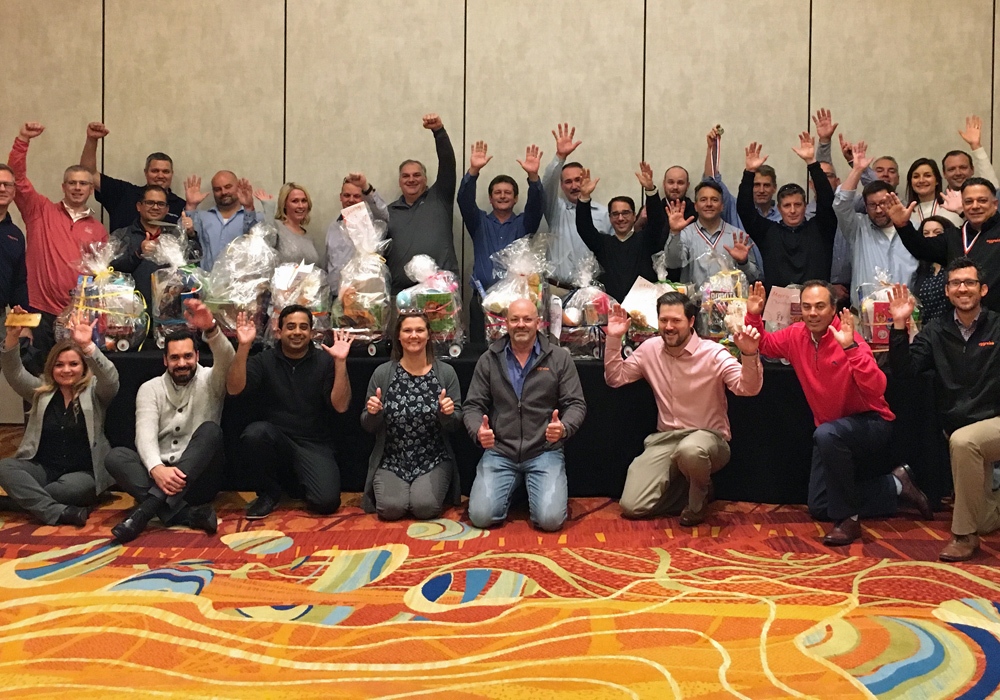 A group of people posing for a picture in a conference room after a successful Toy Donation drive.