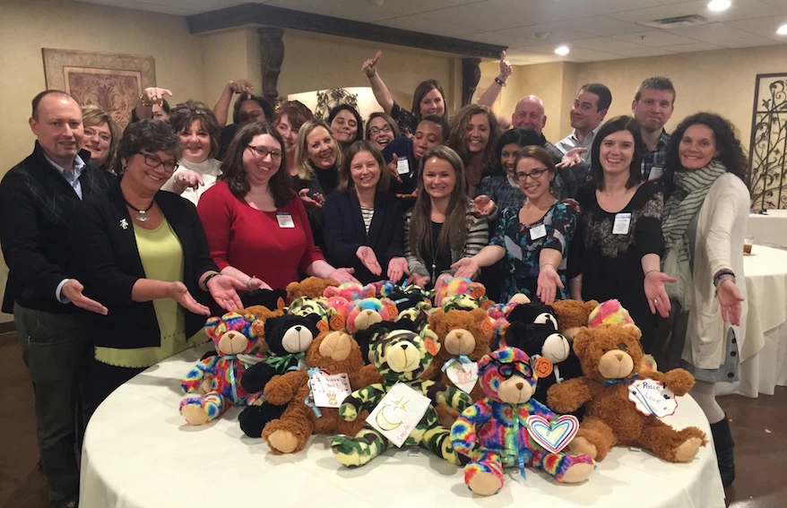A group of people with adorable teddy bears.
