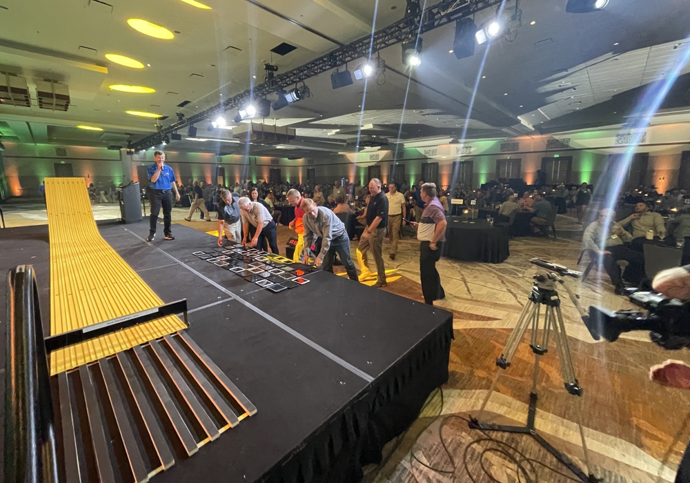A group of people standing on a stage in a room.