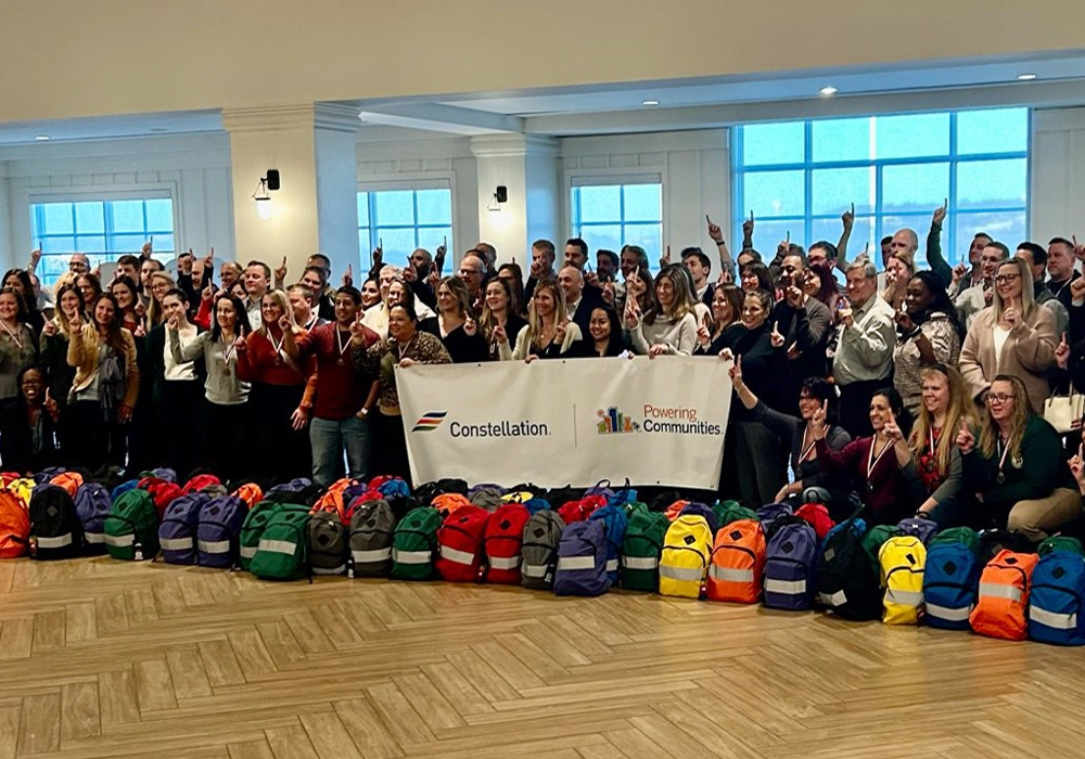 A group of people posing for a photo with backpacks.