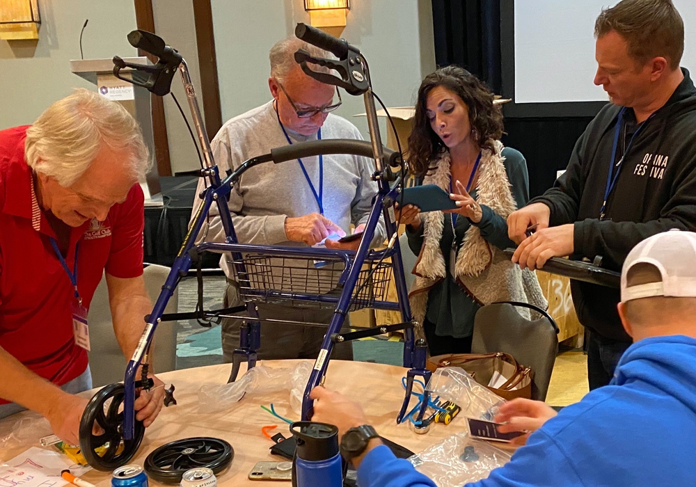 A group of people working on a walker.