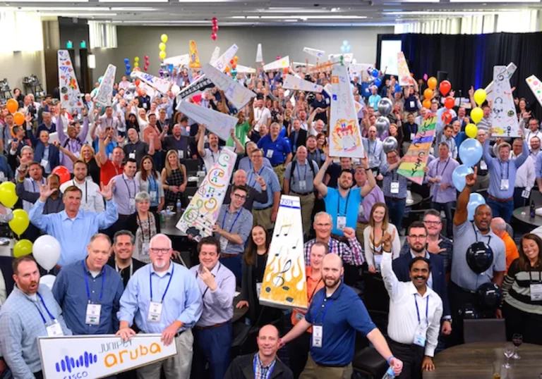 A group of people holding up signs in a conference room.