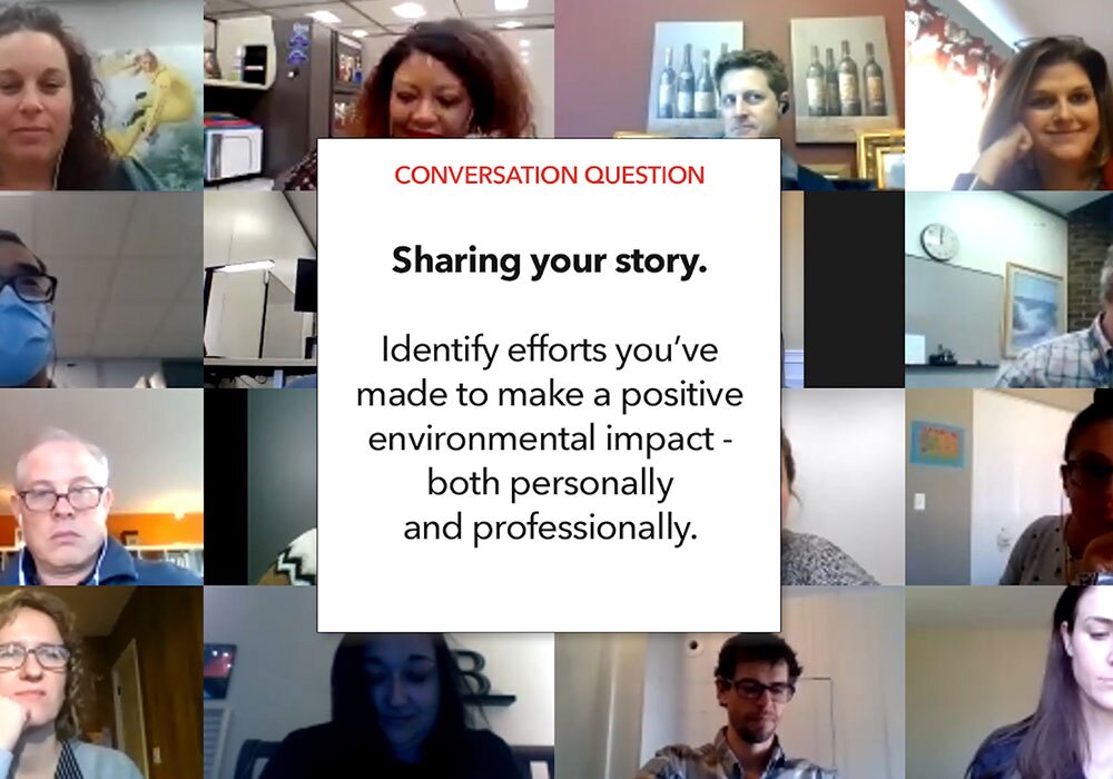 A group of people in a video conference room.