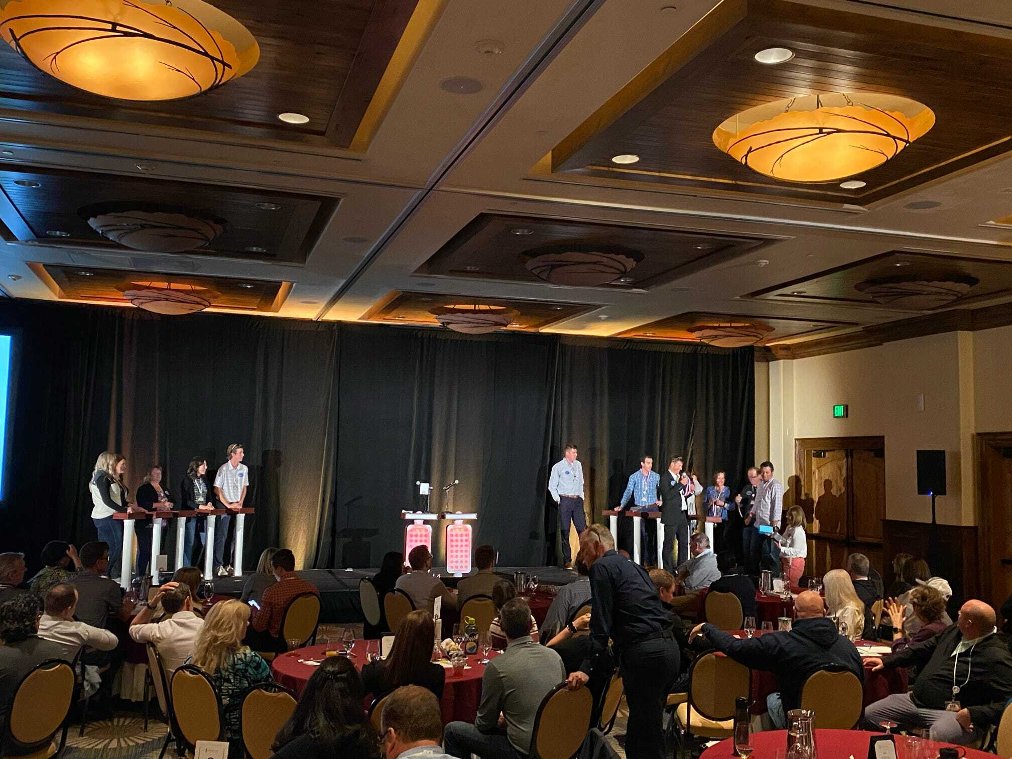 A group of people standing in front of a stage.