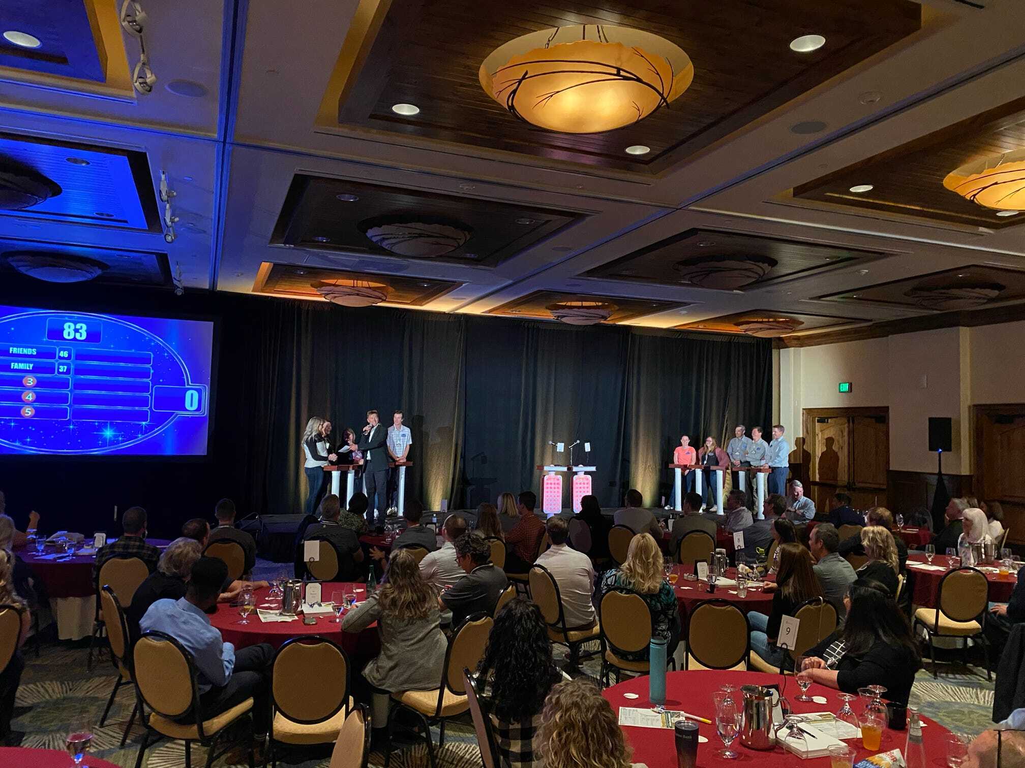 A group of people sitting at tables in a large room.