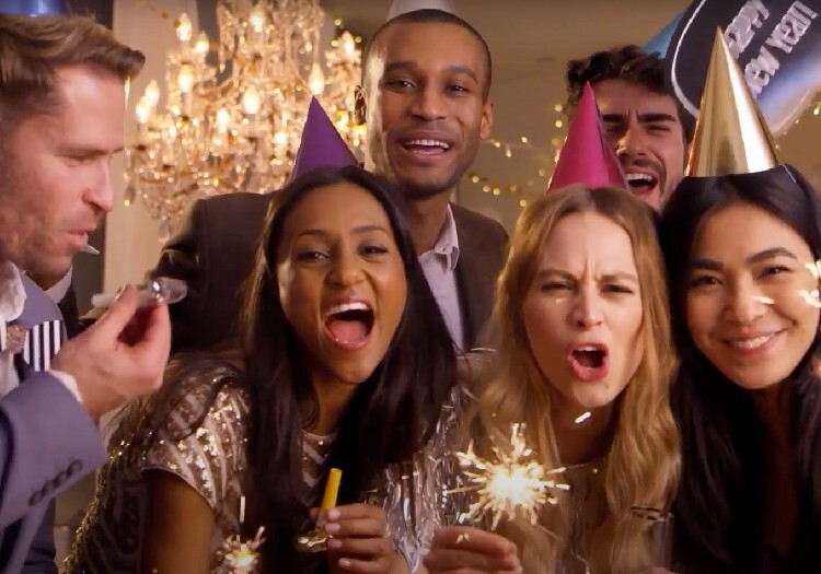 A group of friends having a party with sparklers.