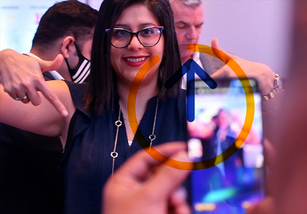 A woman is taking a picture with her phone.