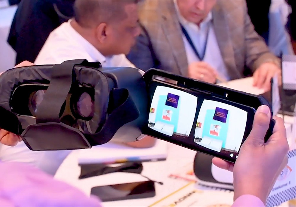 A person holding a vr headset at a conference.