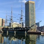 A tall ship docked in a body of water.