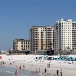 A beach with many people on it.