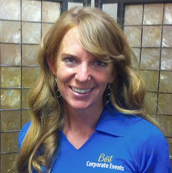 A woman in a blue shirt smiling for the camera.