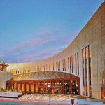 A building with a curved roof at dusk.