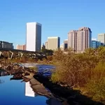 A city skyline reflected in a river.