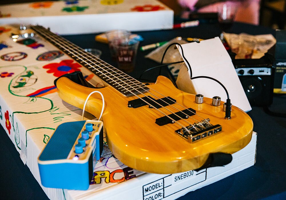 A yellow guitar sitting on a table.