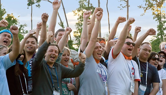 A group of people raising their fists in the air.