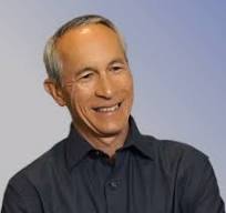 A man in a black shirt with his arms crossed.