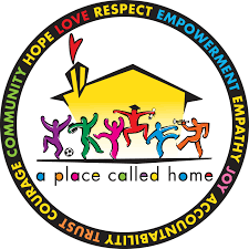 Logo with the text "A Place Called Home" featuring colorful, abstract figures in front of a house. The surrounding circle includes words like "Hope," "Love," "Empowerment," and "Community.