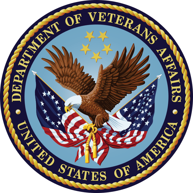 The emblem of the U.S. Department of Veterans Affairs features an eagle holding flags and a ribbon, a blue sky background with stars, and the text "Department of Veterans Affairs United States of America.