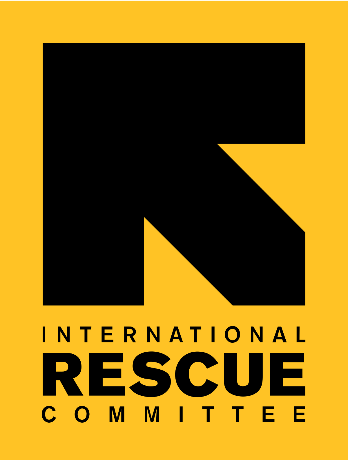 The image shows the logo of the International Rescue Committee. It features a large black arrowhead-like design on a yellow background, with the organization’s name in bold black letters underneath.