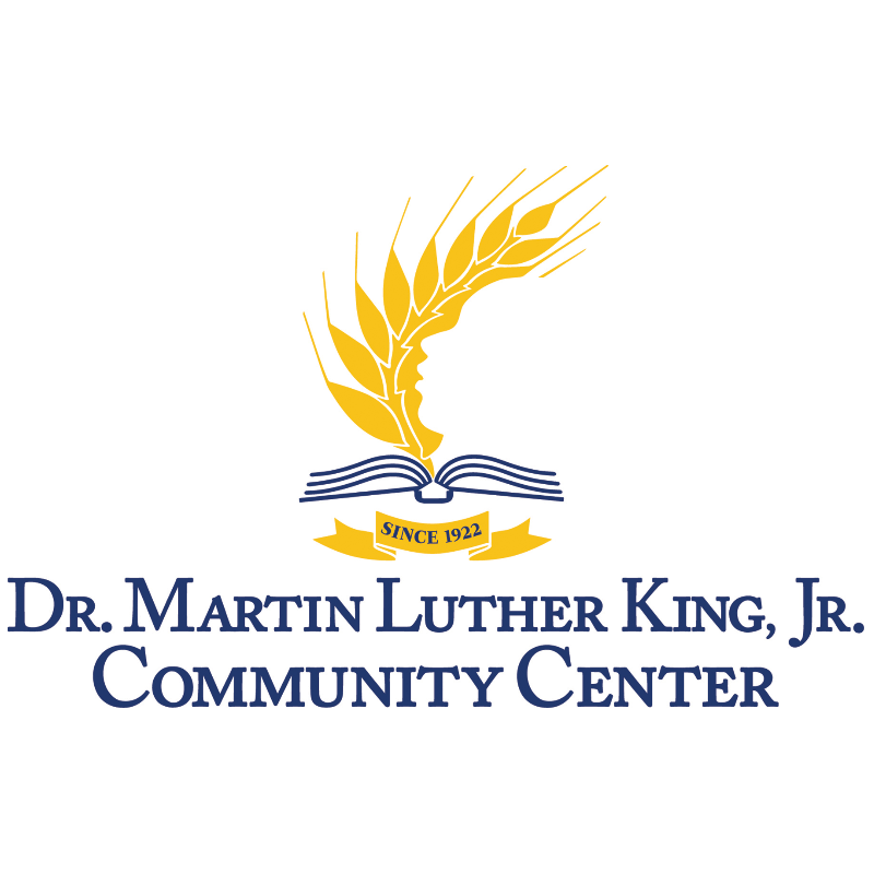 Dr. Martin Luther King, Jr. Community Center logo featuring a golden wheat stalk above an open blue book with "Since 1922" written on it.