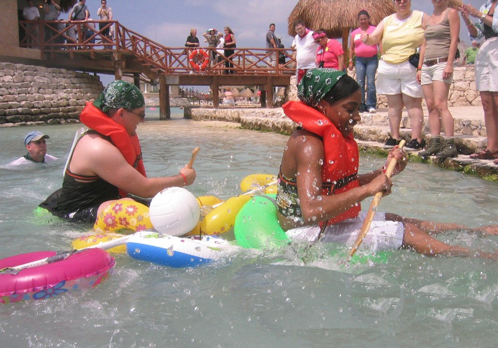 A group of people playing in the water.