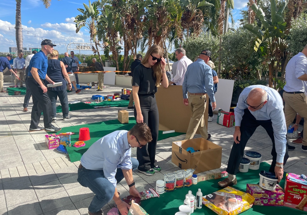 A group of people working on a putting green.