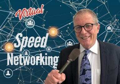 A man in a suit and tie holding a microphone.