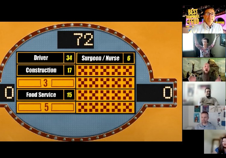 A group of people in a video conference room.