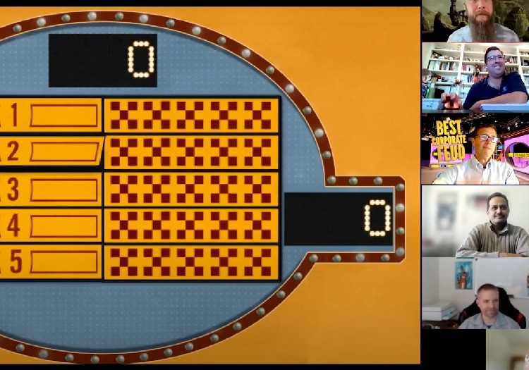 A group of people sitting around a game board.