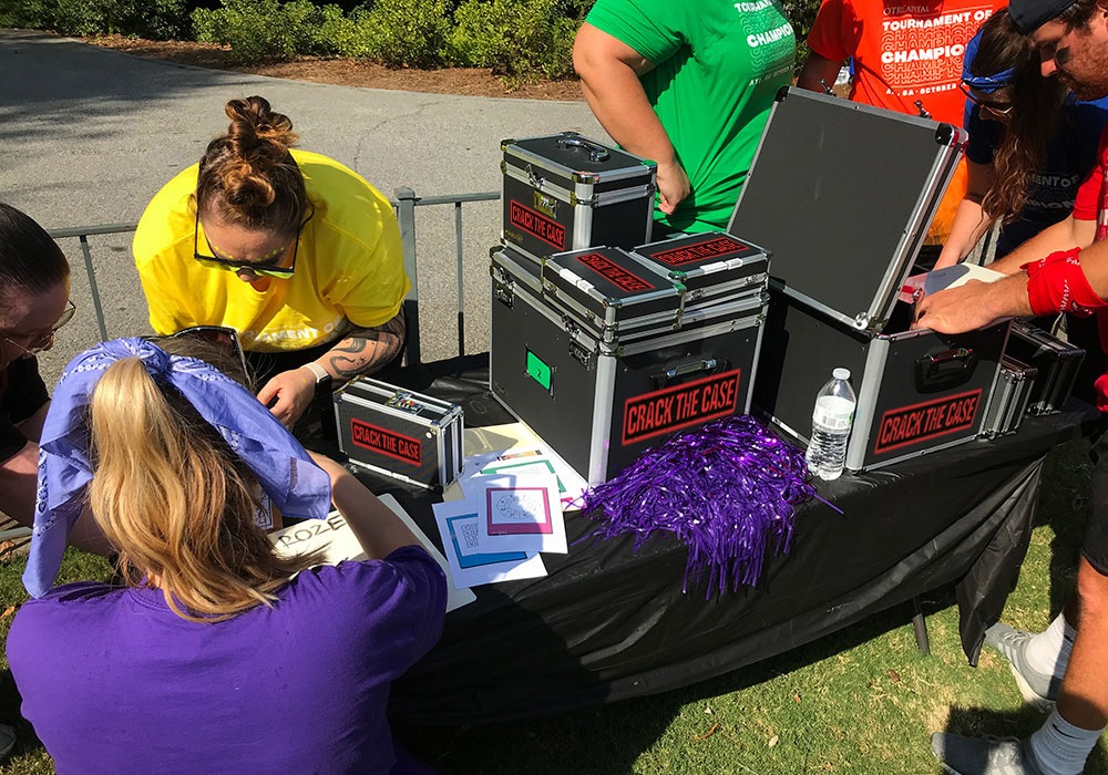 A group of people standing around a table with boxes.