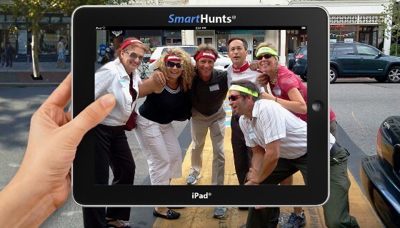 A group of people taking a picture on an ipad.