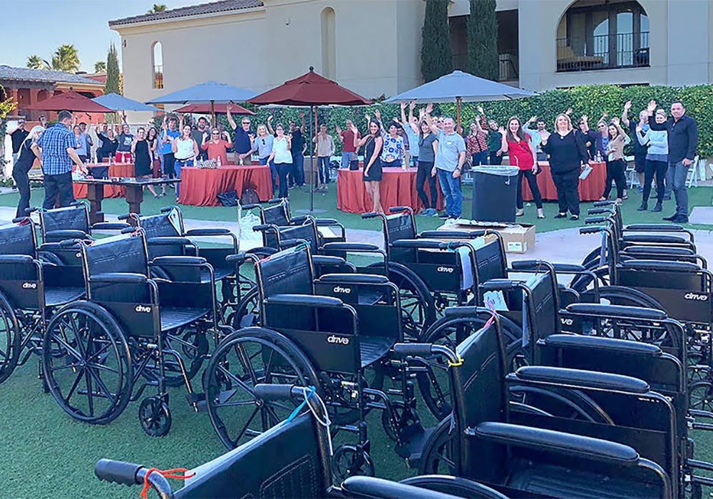 A group of people standing around a group of wheelchairs.