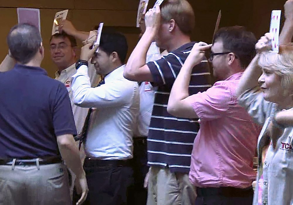 A group of people with their hands up in the air.