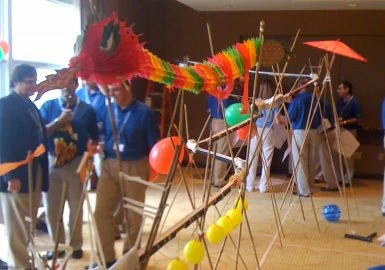 A group of people standing around a large structure.