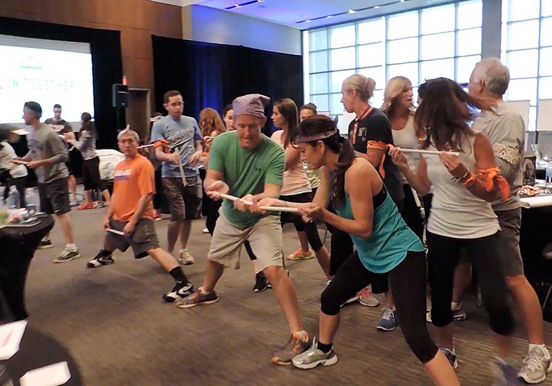 A group of people playing a game of tug of war.