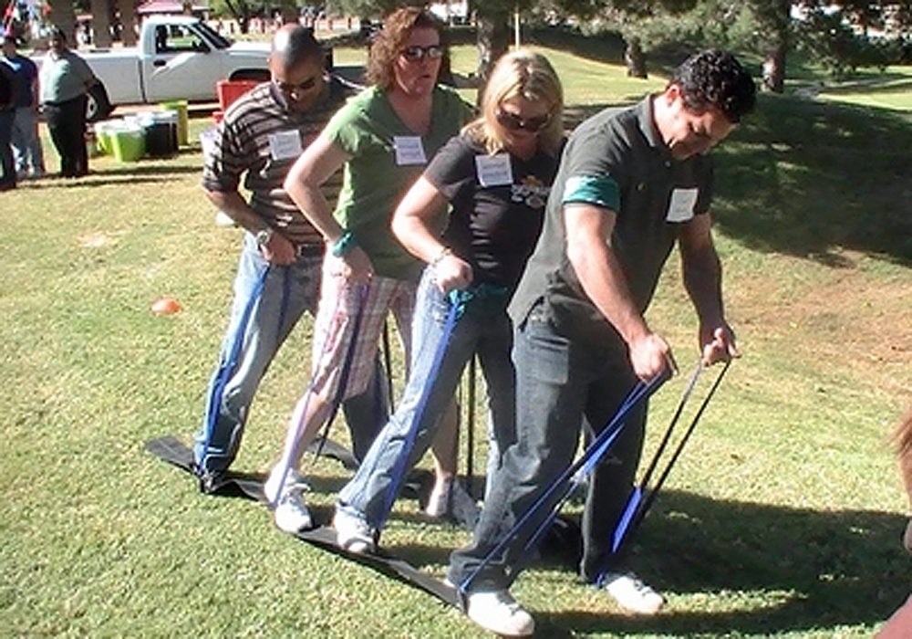 A group of people standing in a grassy area.